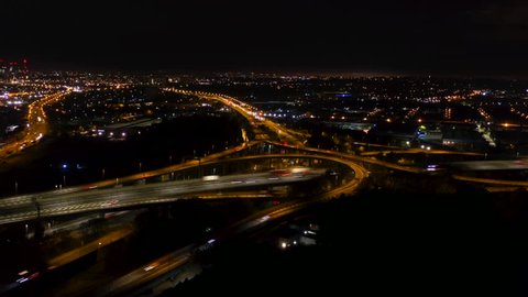 Birmingham aerial hyperlapse view of spaghetti junction motorway traffic at night.