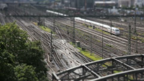 small world of a train station, tilt shift miniature scene of an departing train in Munich - Germany, little people