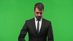 Businessman on green screen chroma key background holding and reading a book