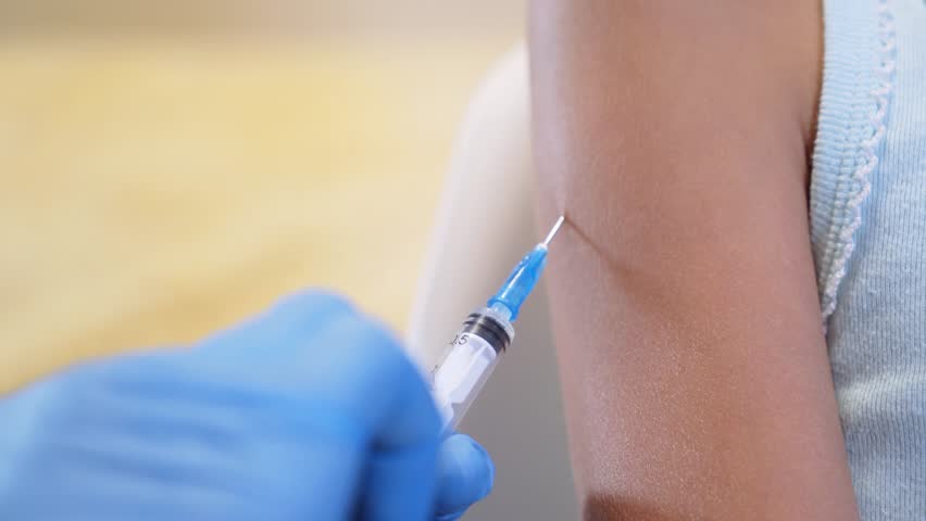 Shot of human hands making an injection with a syringe. coronavirus vaccine | Shutterstock HD Video #1018076443