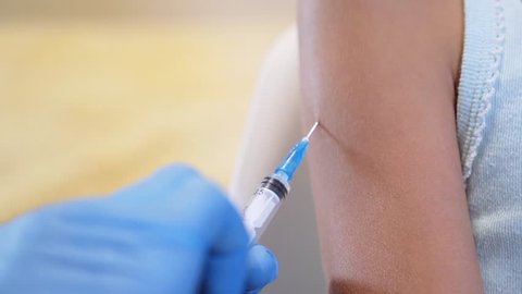 Shot of human hands making an injection with a syringe. coronavirus vaccine