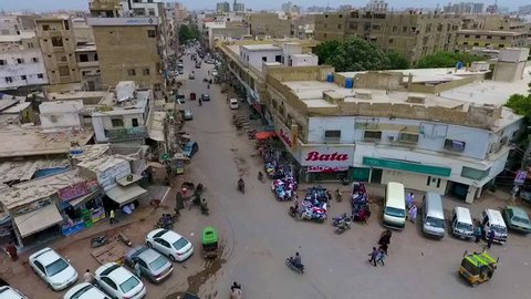 Aerial panning shot of Pakistan roundabout. Cars are parked & cleaners are busy, bike riders going, street hawkers standing. Karachi, Pakistan. ??8th ?July 2018