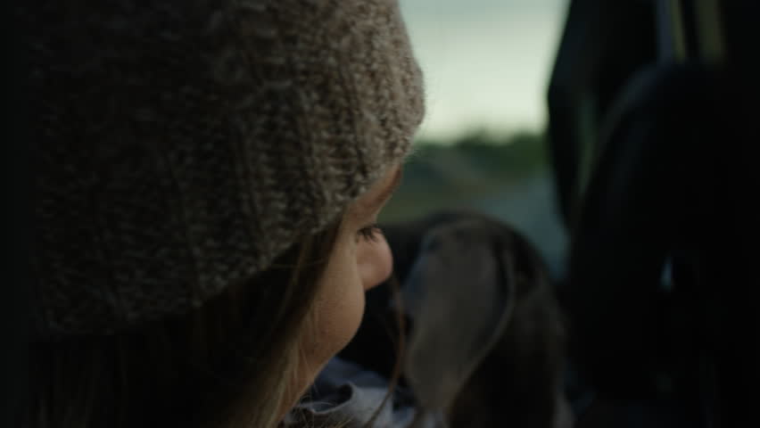 Happy Woman, Holds Puppy In Her Lap In Passenger Seat, Breeze Blows Through Her Hair, Slow Motion