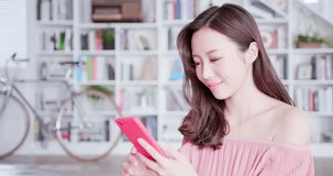 young woman use smart phone and feel happy at home