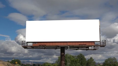 Time lapse billboard straight on view ready for your information with rolling clouds behind it