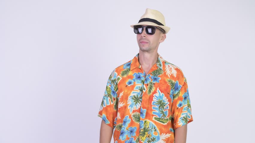 Excited tourist man removing shirt and ready for vacation