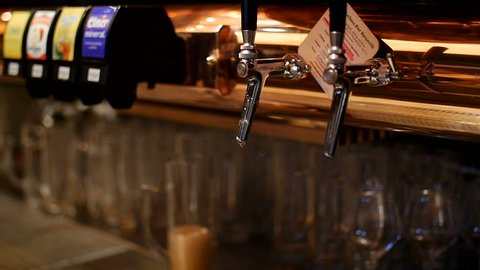 Beer Tap in European Swiss bar, Beautiful colors of a cosy space with glasses and blurred background