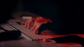Hacker hands meticulously hacking in darkness with cast red light and a blinking white/blue light for dramatic effect. - Powered by Shutterstock - Get 15% off with code: PIKWIZARD15