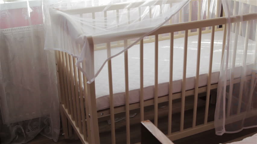 an empty crib for infants,in the room there is a new crib for babies, waiting for a baby, buying a new crib Royalty-Free Stock Footage #1018104490
