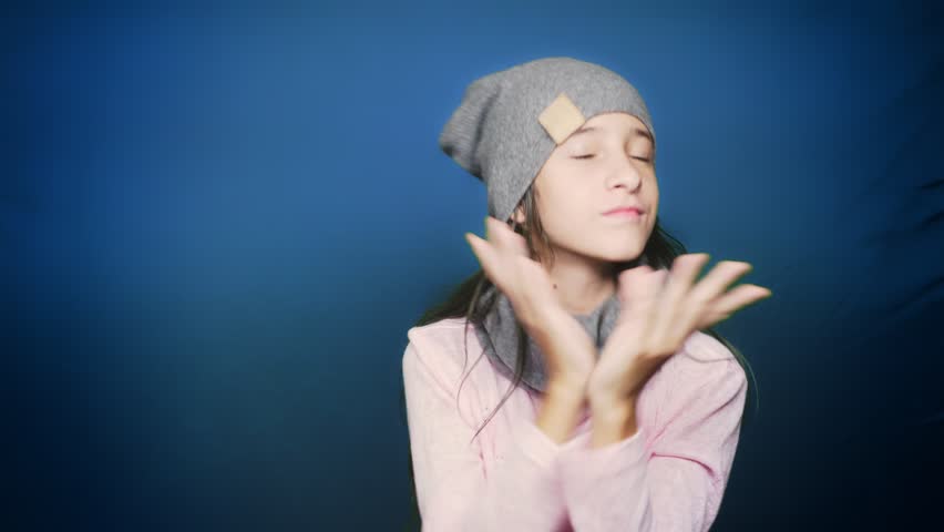 beautiful teen girl in autumn clothes , posing at camera over blue background