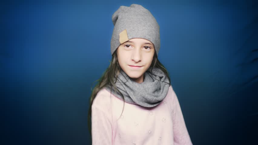 beautiful teen girl in autumn clothes , posing at camera over blue background