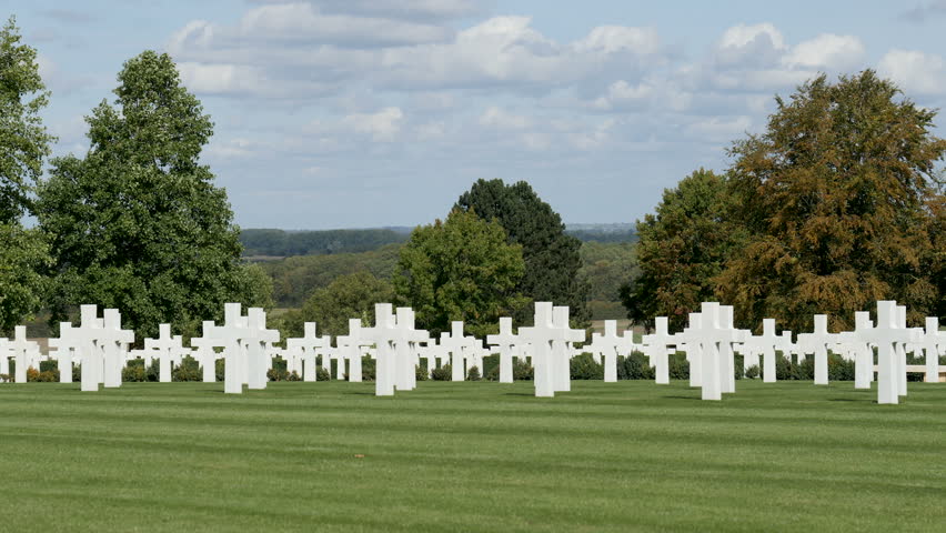Zoom in-Field of white crosses marking the graves of Americans killed in the European theater of war at the WWII American Cemetery near Cambridge, England