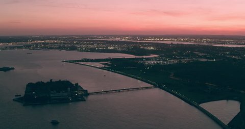 Aerial view of Ellis Island and the Upper Bay, New York City, dim sunset light. Wide shot. 