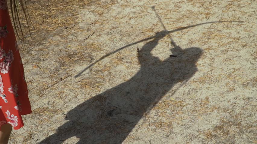 Shadow of female archer on the ground