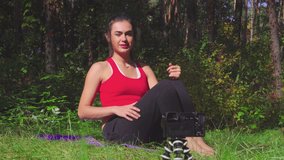 Young brunette woman making sport exercises in sunny forest fit female working out