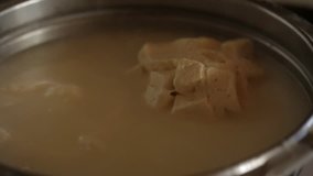 Video about homemade cheese production. Cheese mass is cooked in a saucepan.