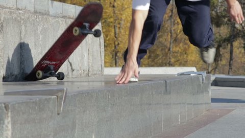 Skateboarder try a grind trick on ledge and falling down, slowmotion