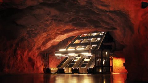 Stockholm city's beautiful metro station Radhuset. Fire style subway with dark atmosphere. Scandinavian place with escalator and empty place 