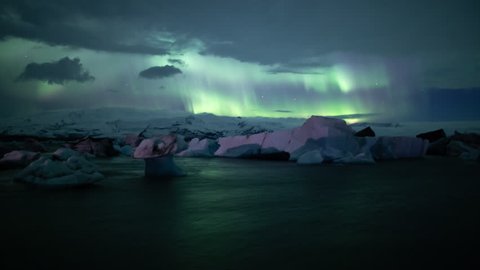 Aurora borealis over strange iceberg shapes in Jokulsarlon glacier bay, Iceland.mov
