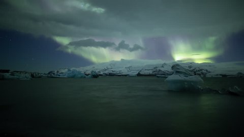 Bright Aurora Borealis over floating icebergs in Jokulsarlon glacial bay, Iceland.mov
