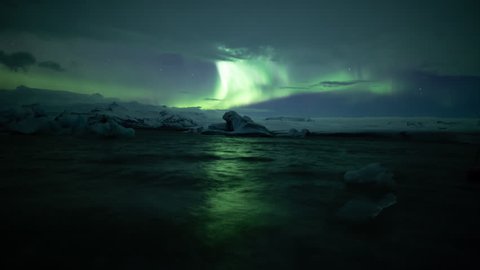 Aurora borealis over icebergs, reflecting in water, Jokulsarlon Iceland.mov
