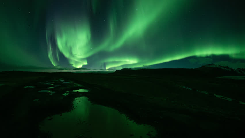 Bright realistic Aurora Borealis over mountains, reflecting in puddles, Skaftafell Iceland.mov
 | Shutterstock HD Video #1018162867
