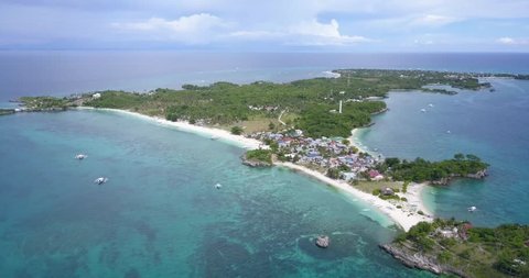 Aerial drone footage of the beautiful Malapascua Island of Cebu the Philippines in the clear blue waters of southeast asia