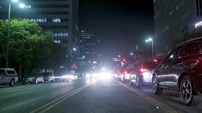 Night city traffic. 4K time lapse of a busy city street and cars driving leaving light trails
