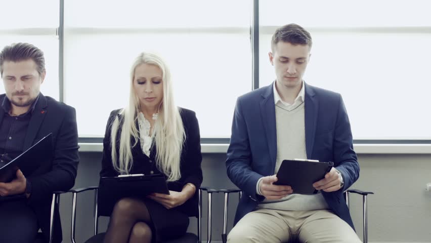 Business people waiting for job interview. Three candidates competing for one position having cv in his hand. Group of stressful university students waiting for exam test. Royalty-Free Stock Footage #1018171642