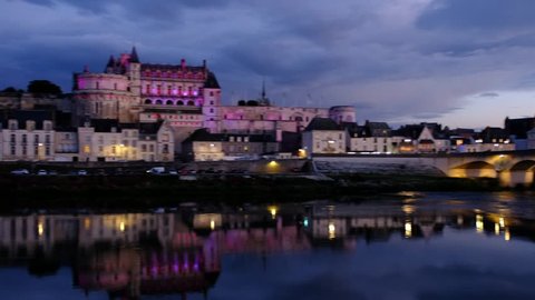 Amboise-France/Loire - October 10 2018 - The Royale d'Amboise castle reflecting in the Loire river at dusk  Motion view 