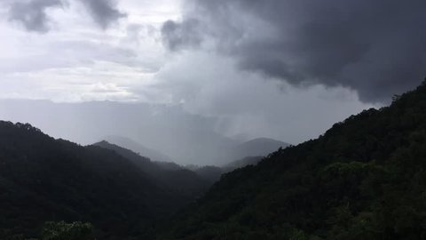 Mountains landscape with cloud moving and raining with the light of sunshine in middle of nature. in the north of Thailand 