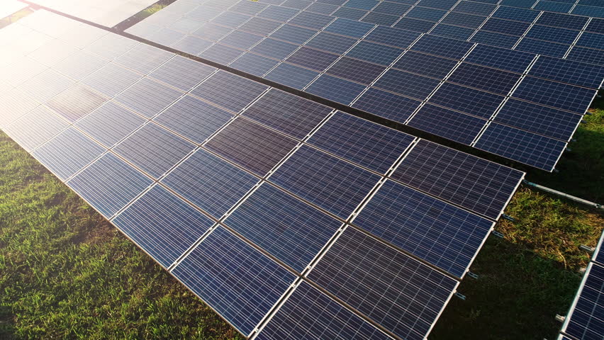4K Aerial view shot of Solar Panels Farm (solar cells) with sunlight.Drone flight fly over top view of solar panels field renewable green alternative energy concept in Thailand. | Shutterstock HD Video #1018184167