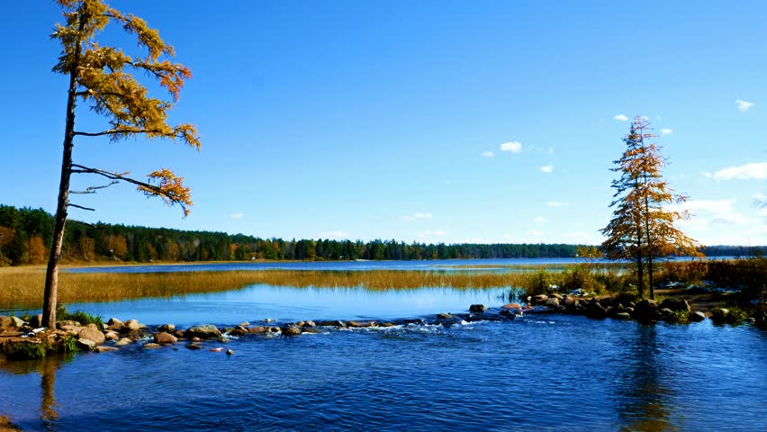 Lake Itasca held behind a man made dam at the headwaters of the Mississippi River at Lake Itasca State Park in Minnesota. Tourists often walk on the rocks to say they have walked across the river.
