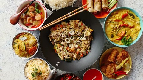 Asian oriental food composition in colorful dishware, served on stone, top view. Chinese, vietnamese, thai cuisine set. With copy space