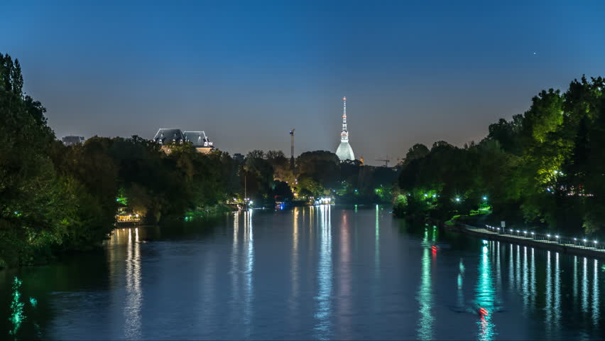 Turin skyline view of river and Mole Antonelliana at night Italy.