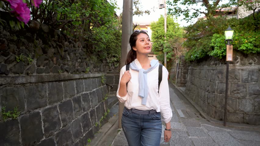 beautiful lady walking in the path in sunny day with a cheerful face