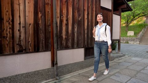 elegant female traveler visiting the Japanese traditional building
