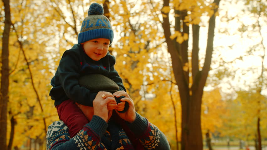 Grandfather playing with his grandson in the autumn park Royalty-Free Stock Footage #1018214371