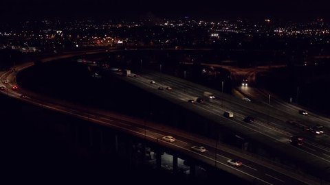 Motorway at night panning aerial establishing shot of Birmingham UK.