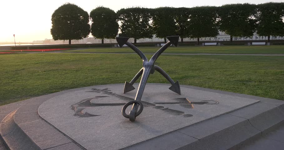 4K high quality sunrise video of St.-Petersburg's beautiful vintage architecture and old anchor monument at Rastralnie columns beacons at Neva River in Vasilyevsky Island spit, Finnish Bay, Russia