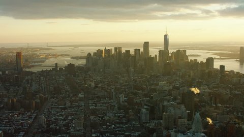 Aerial view of downtown Manhattan cityscape and skyline, New York City, bright winter sunset light. Wide shot. 4k shot with a RED camera.