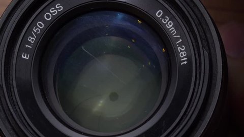 Macro closeup of cleaning camera's lens with soft cloth - video in slow motion