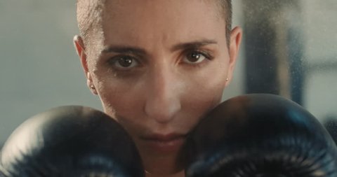 portrait beautiful kickboxer woman ready for training fighter looking confident tough female athlete boxer wearing boxing gloves in fitness gym serious expression close up