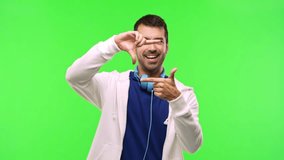 man with sweatshirt and music headphones on green screen chroma key background  focusing face. Framing symbol