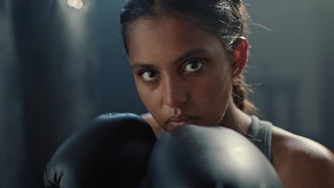 portrait indian kickboxing woman ready for training fighter looking confident at camera tough female kickboxer wearing boxing gloves in fitness gym close up