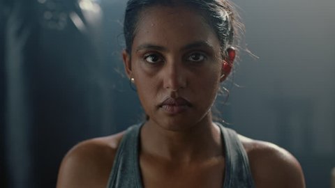 portrait beautiful kickboxing woman fighter looking confident at camera tough female kickboxer fierce sportswoman sweating after training in fitness gym close up