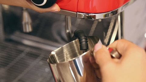 Barista preparing fresh milk for sweet cappuccino in coffee machine. Clouse-up.
