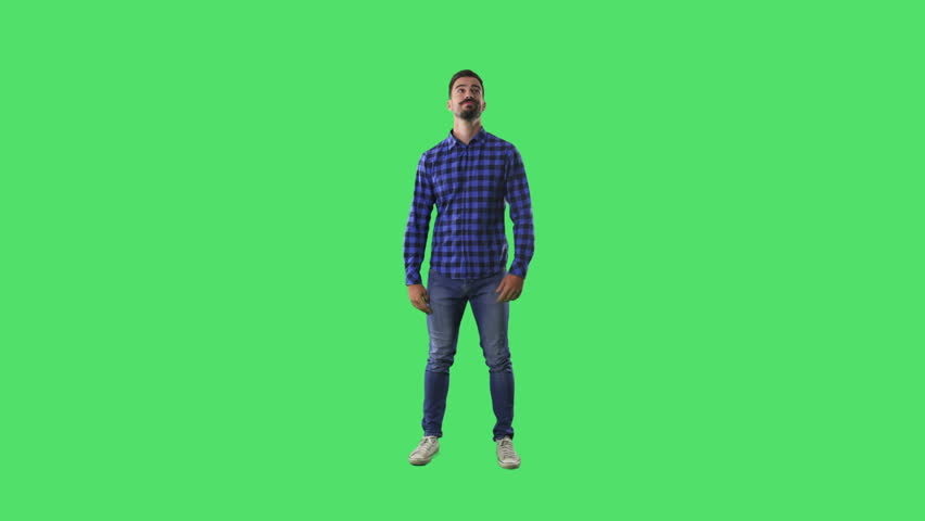 Young bearded modern hipster male waiting bored looking around. Full body isolated on green screen background.