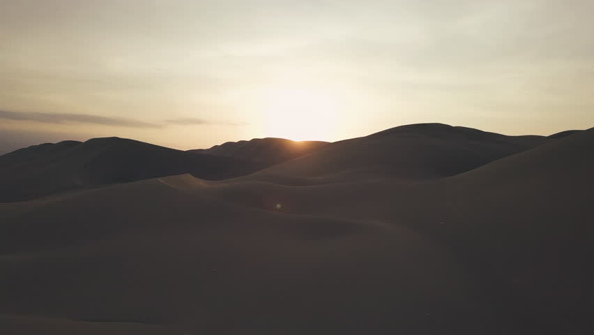 Drone Aerial of Sand Dunes Desert Oasis at Sunrise