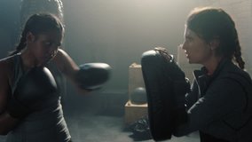 kickboxery woman athlete kickboxing coach training female fitness friends boxing enjoying intense exercise workout together in gym - Powered by Shutterstock - Get 15% off with code: PIKWIZARD15